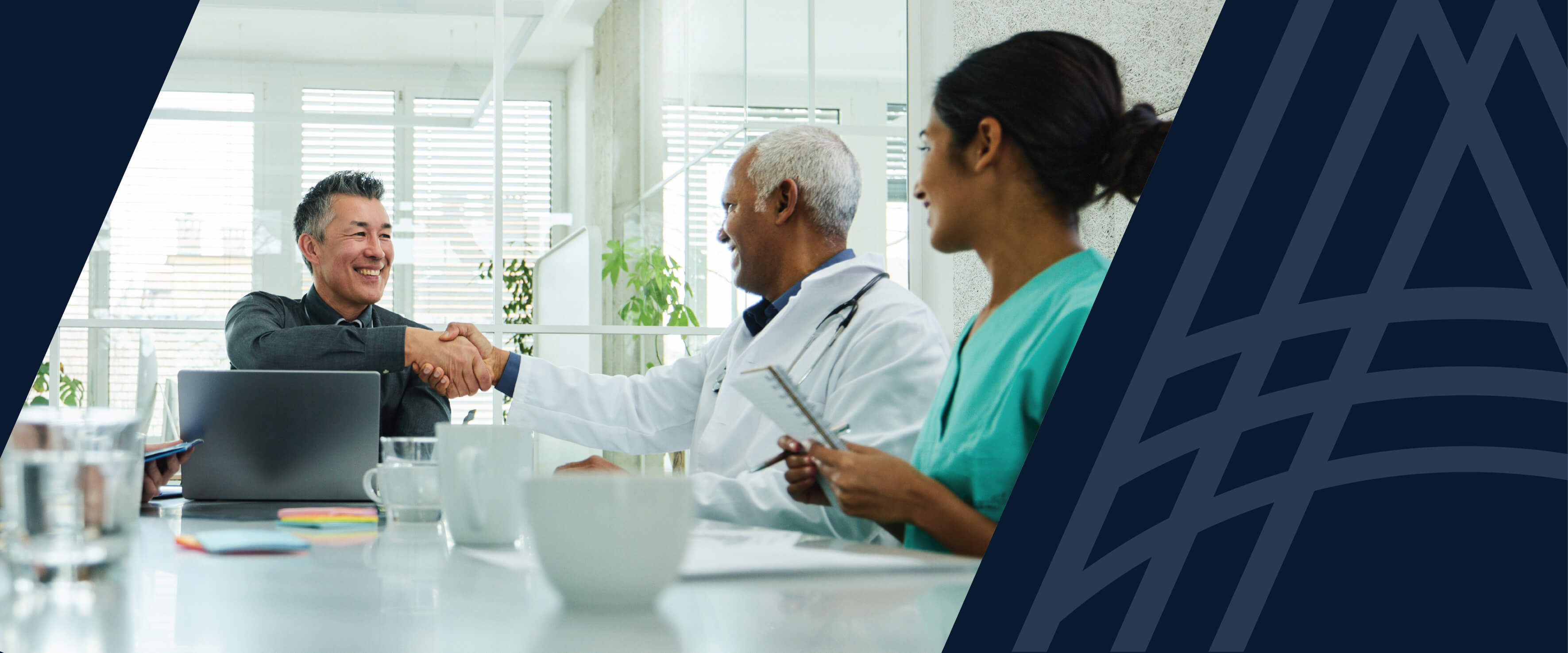 Management leader shaking hands with a medical professional at a Pharma Summit.