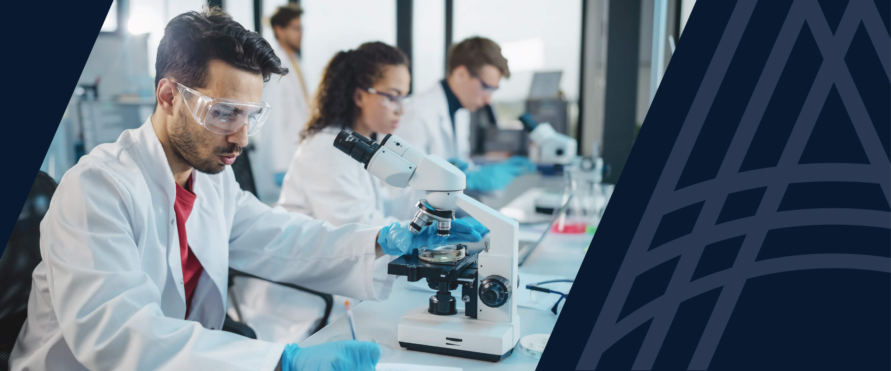 Clinical researchers using microscopes during a clinical trial.