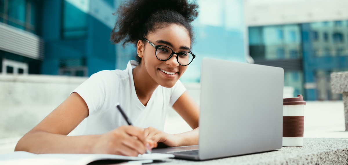 woman on a computer smiling at the camera