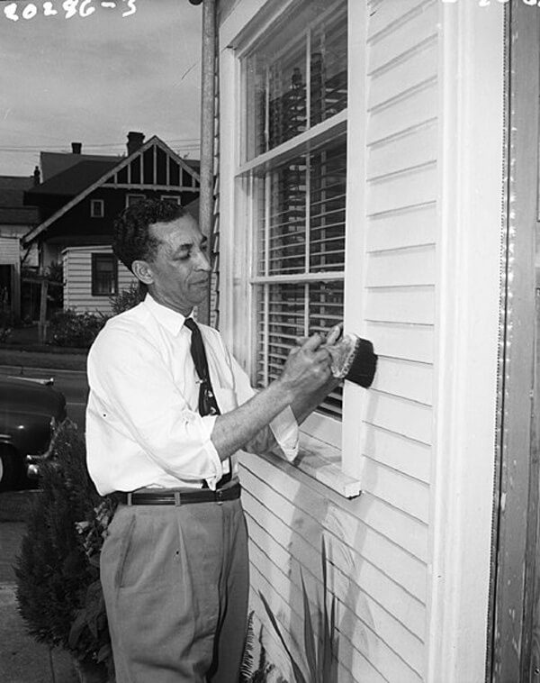 Man painting house exterior using lead paint (1960, Seattle, Seattle Municipal Archives).