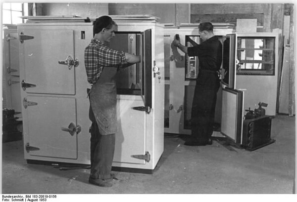 Workers Heinz Richter and Josef Weiss (back) setting up refrigerators for a trade fair in Leipzig, Germany (Schmidt, 1953).