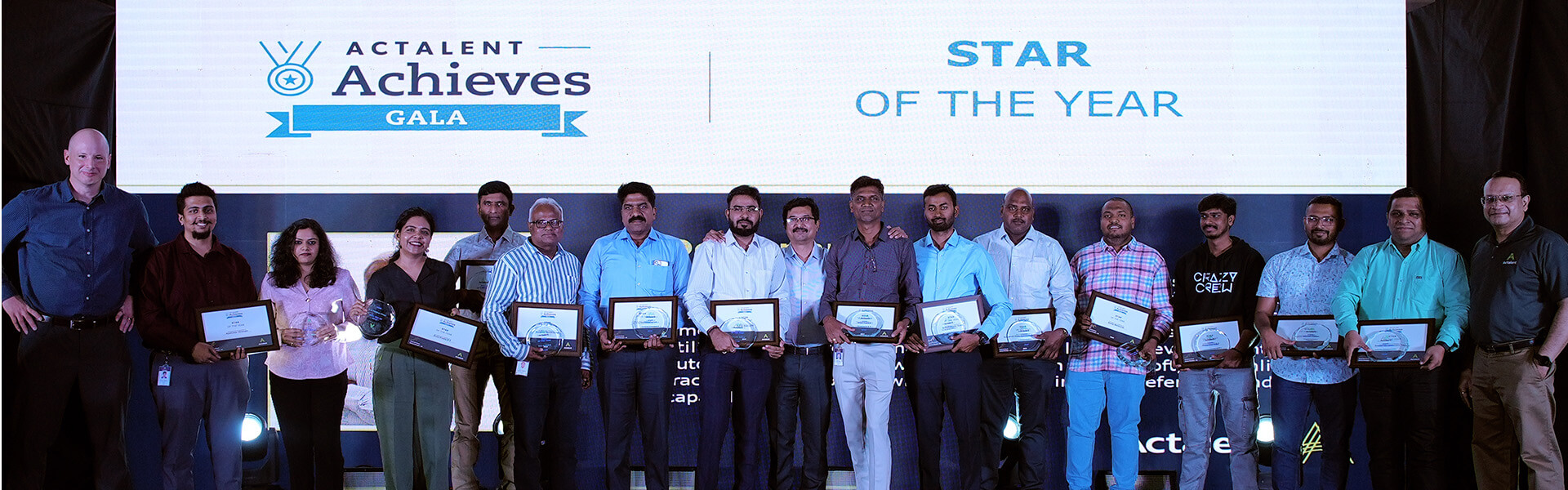 group of achievers holding their Actalent awards at 2025 gala