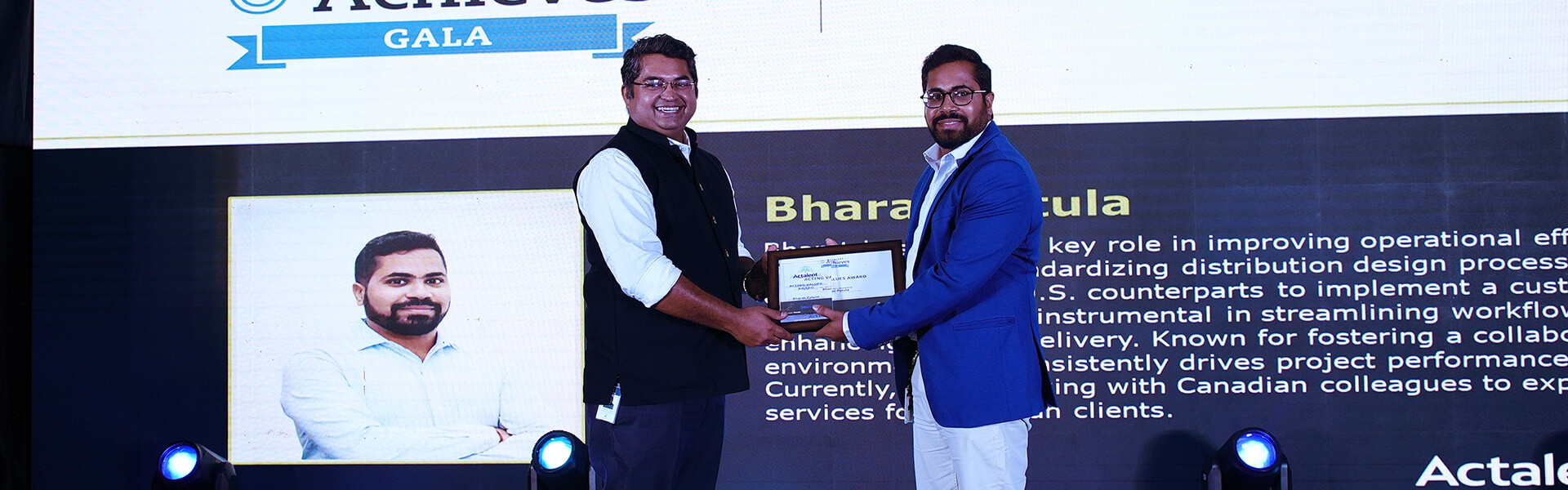 two gentlemen on stage shaking hands at Actalent Achieves Gala 2025