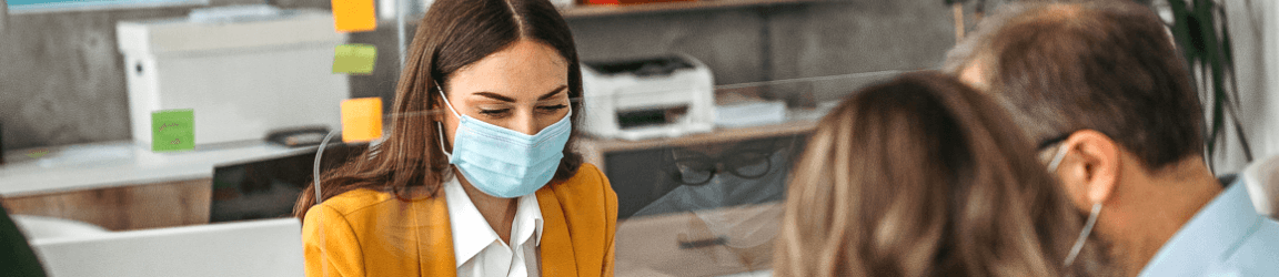 woman wearing a mask looking down
