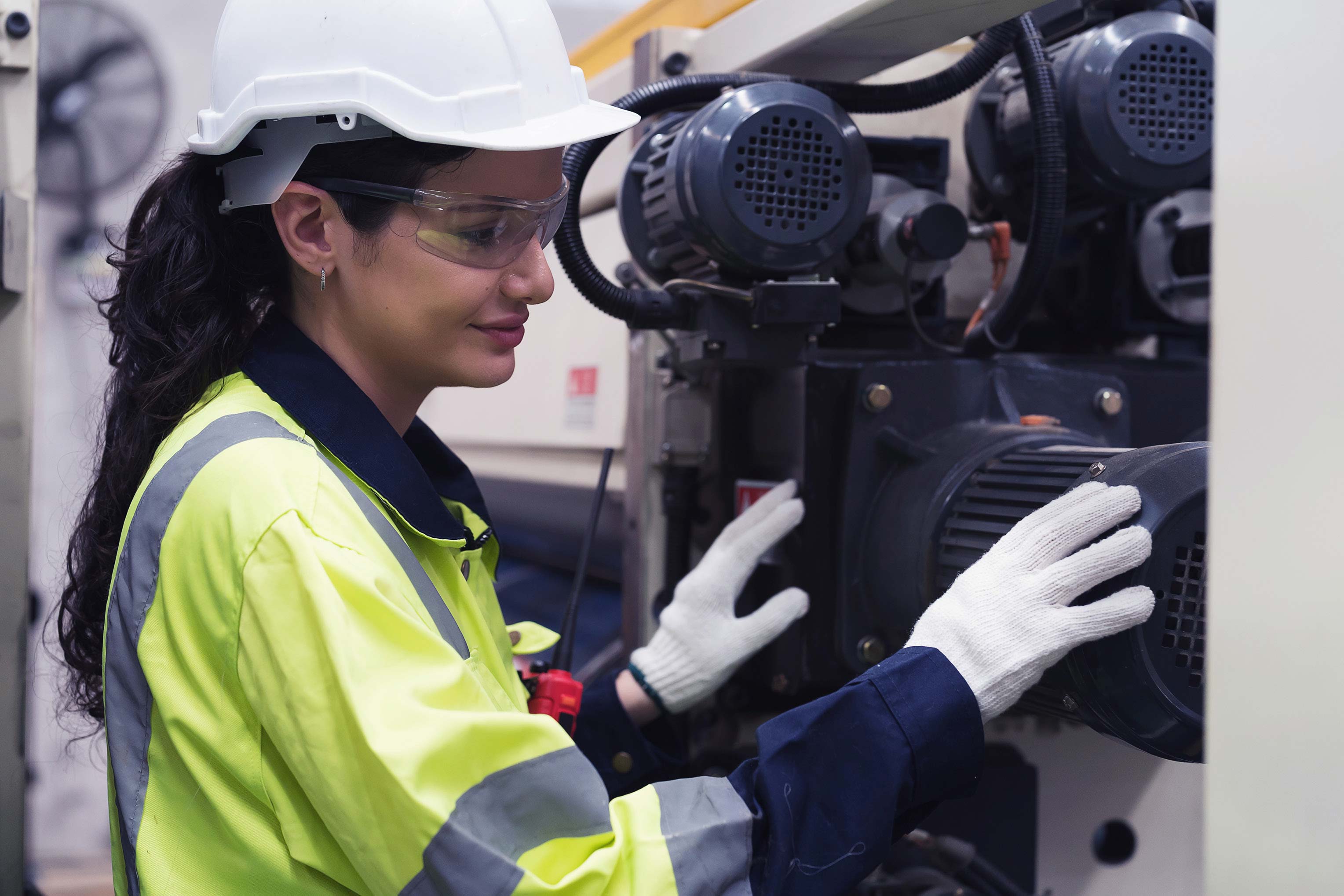 Skilled industrial maintenance technician performs equipment inspection in a manufacturing plant.