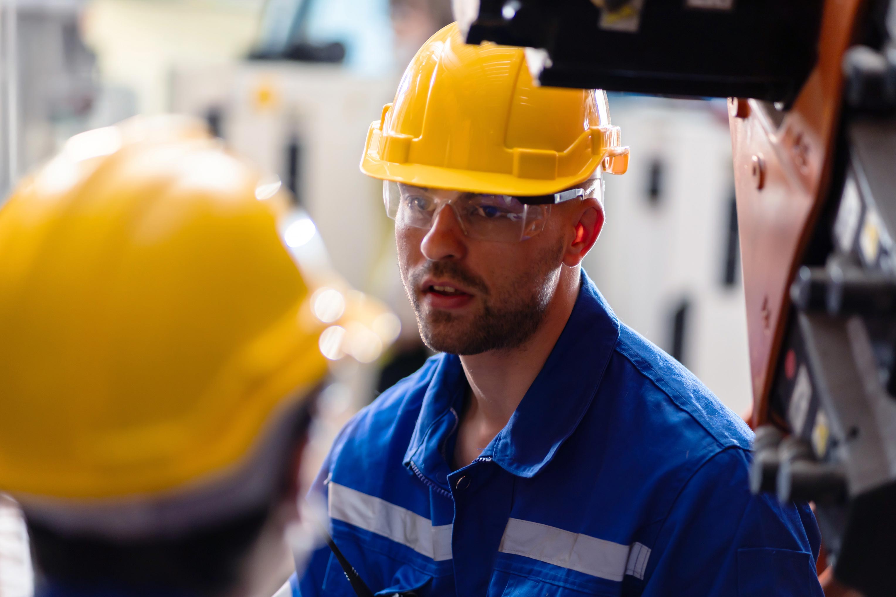 Maintenance technician troubleshoots industrial machinery to support production uptime and reliability.