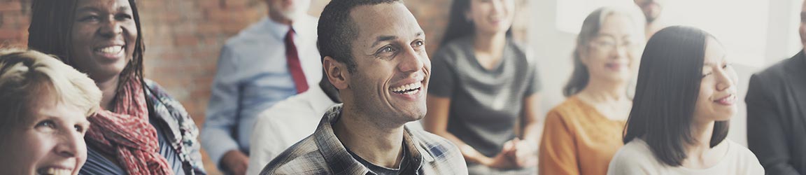 Small group of adults smiling at a meeting