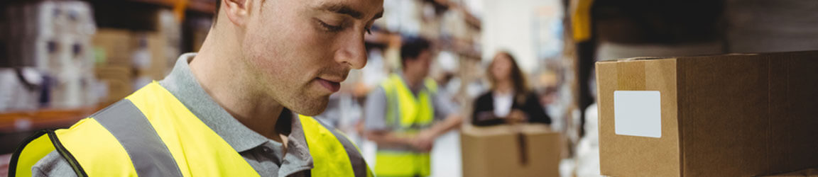 Worker in warehouse with boxes