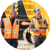 Two construction workers in orange vests
