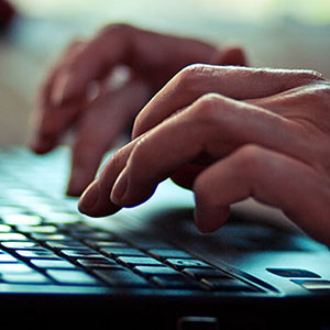 fingers typing on keyboard