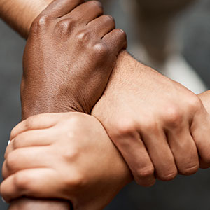 3 hands holding wrist in a triangle