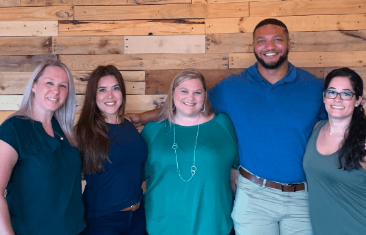 Aston Carter employee group photo of four women and one man.