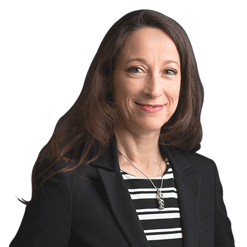 Photo of Shelley Askew.  Brunette, caucasian woman with brown eyes and smile with a black jacket and white and black striped shirt