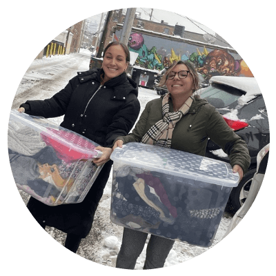 Two Aston Carter employees volunteer at a clothing drive