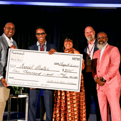 Leaders hold a check they are donating