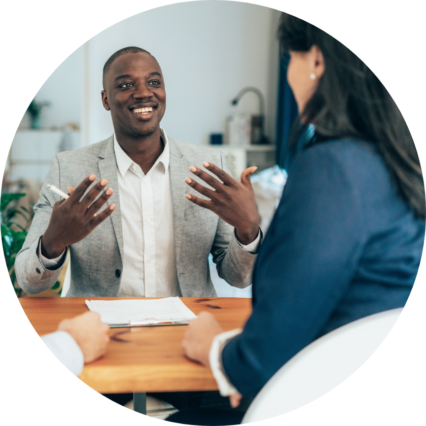 Career Resources Male candidate using positive expression during discussion with recruiter.