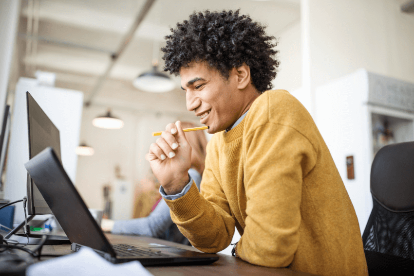 Male job seeker searching for ways to gain competitive advantage in his field on his laptop.
