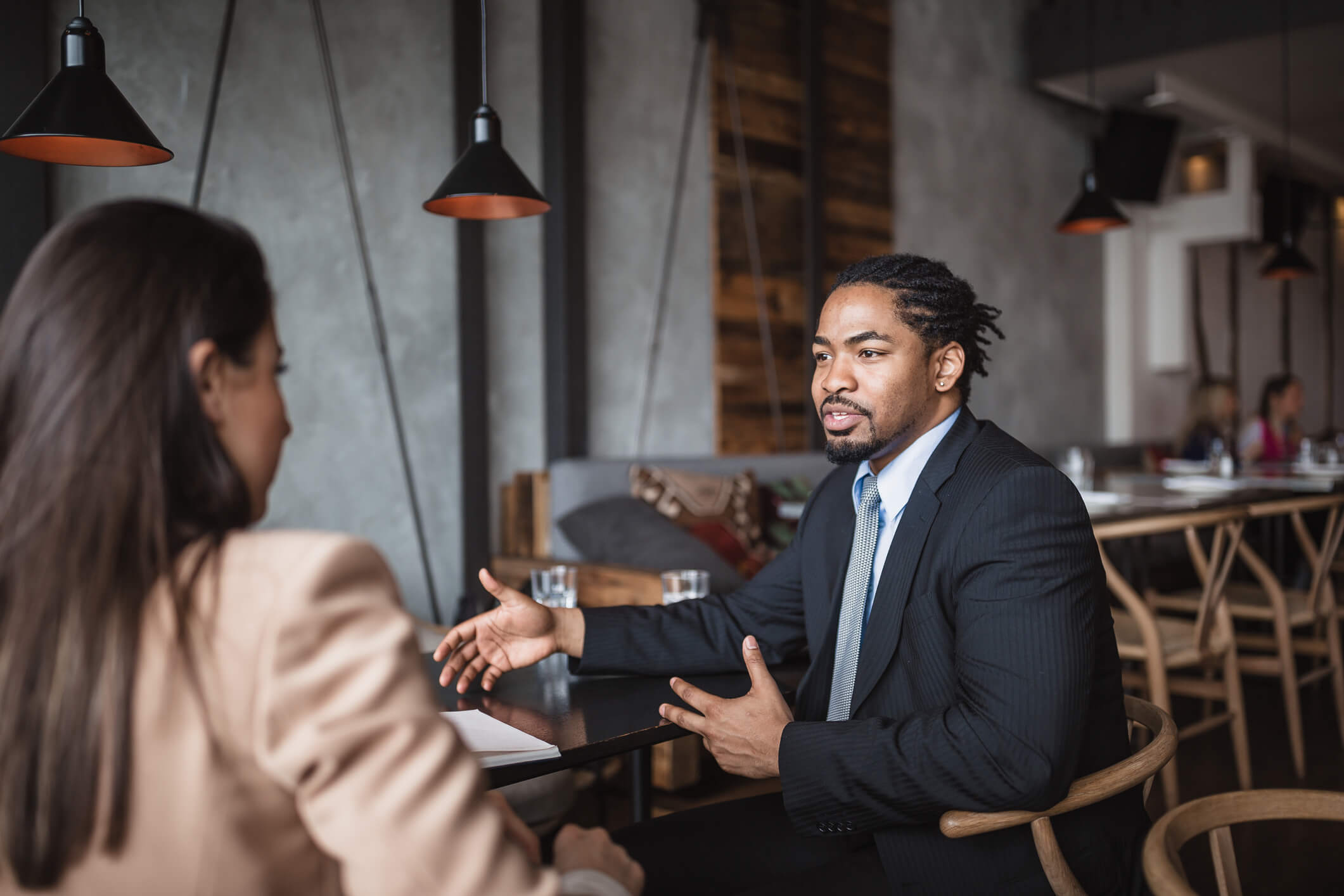 A man and woman having a meeting at a restaurant. 