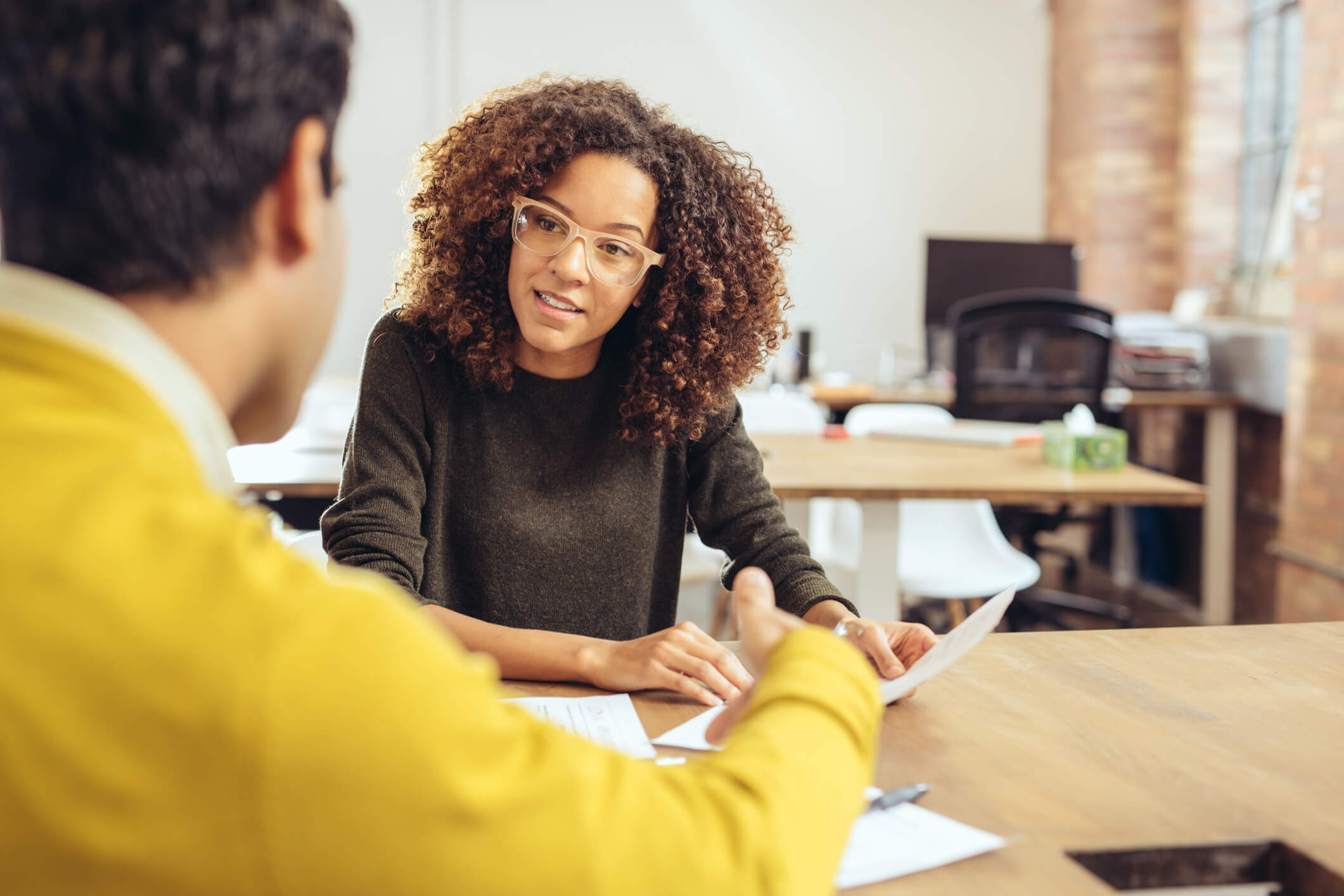 A woman employee providing feedback to her male manager.