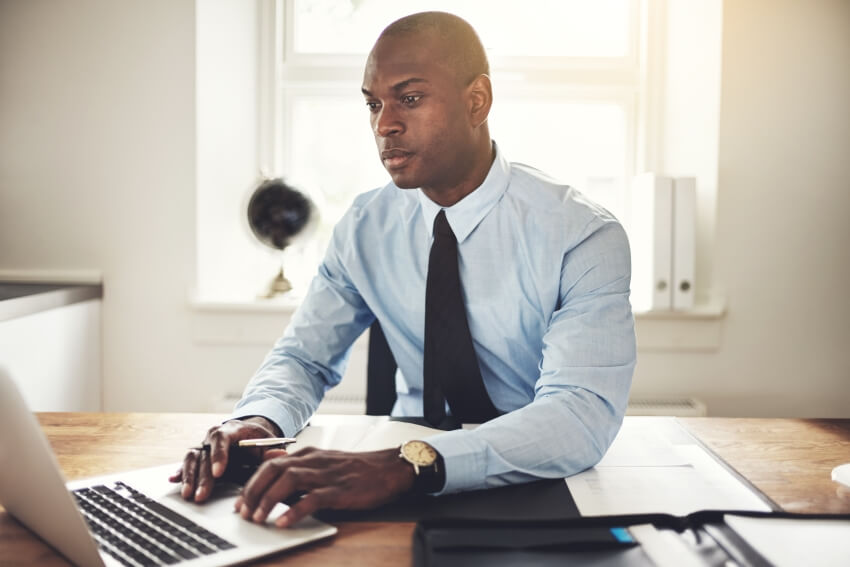 homme d’affaires tapant sur un ordinateur portatif | Astoncarter.com