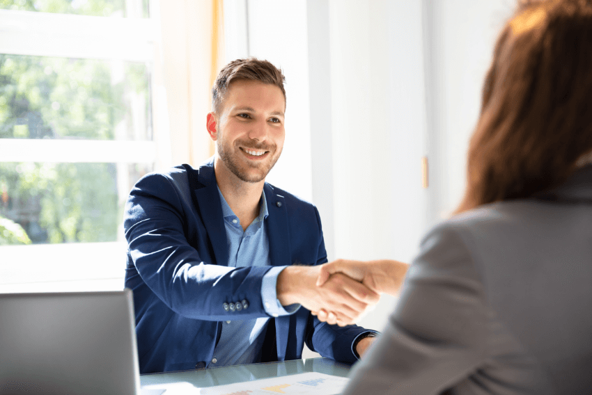 A male recruiter collecting candidate feedback to enhance the candidate experience.