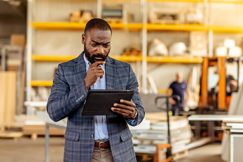 A male business profressional analyzing the impacts of tariffs and how companies can ready their workforce. 