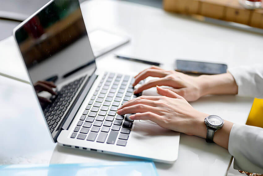 Womans hands typing on keyboard 