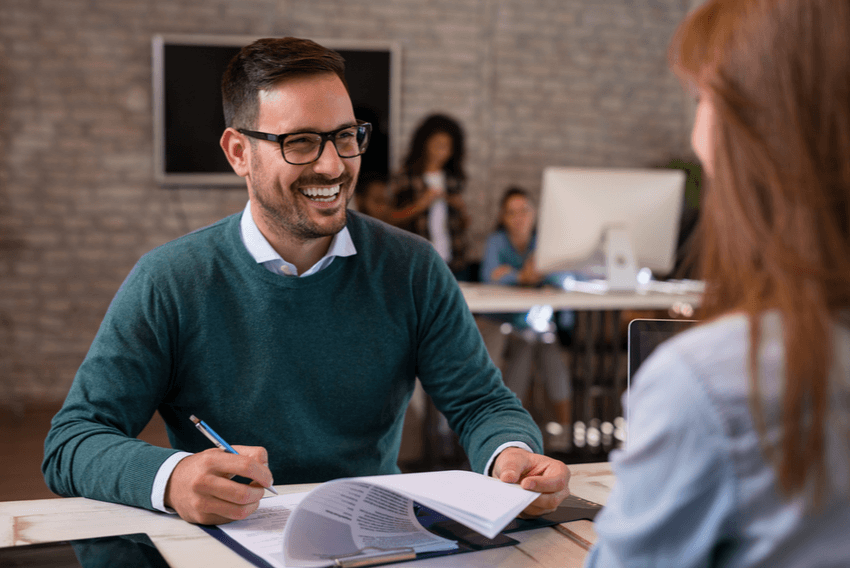man interviewing with women at desk