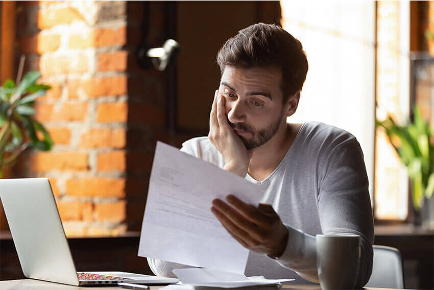 Man reading document. Aston Carter Staffing Articles.