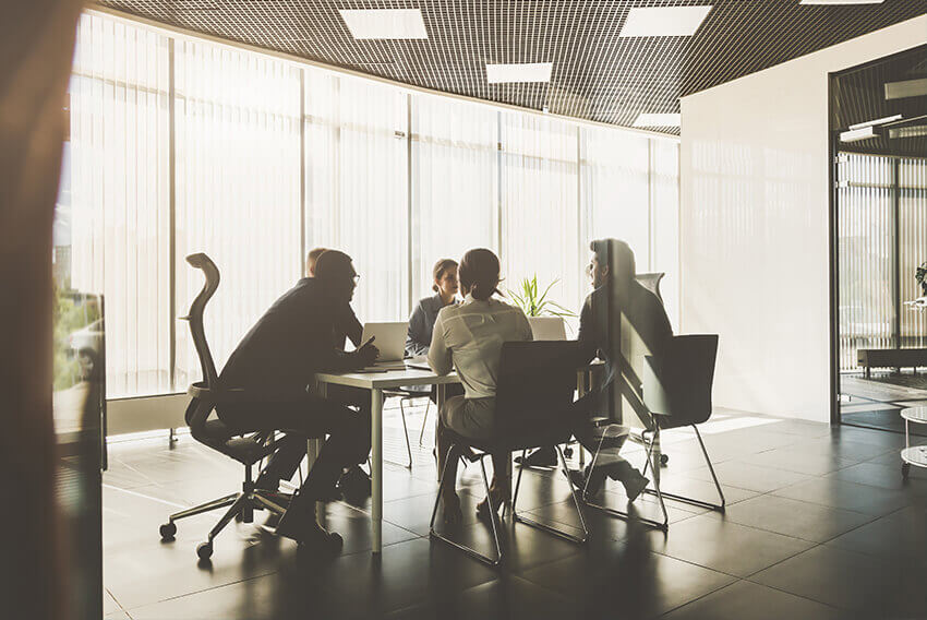 Five employers sitting around a table in a conference room.  Aston Carter Recruitment Articles. 