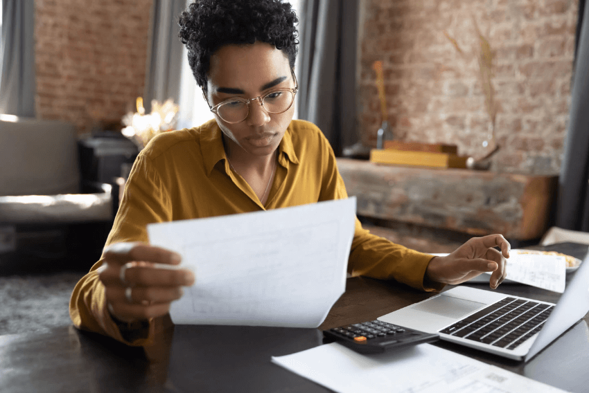 A woman reading about accounts receivable (AR) and accounts payable (AP) roles.