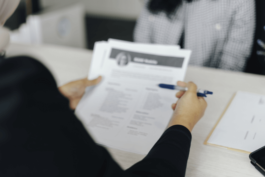Hiring manager reviewing a job seekers resume during an interview.
