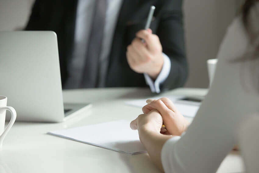 Two people reviewing a document while the man is holding a pen. Aston Carter Recruitment Articles.