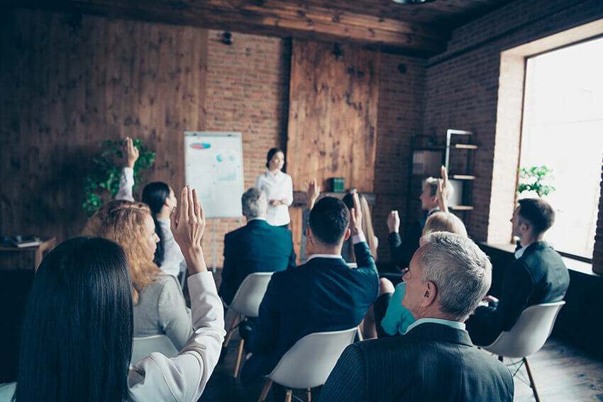 Professionals in a meeting have a discussion.
