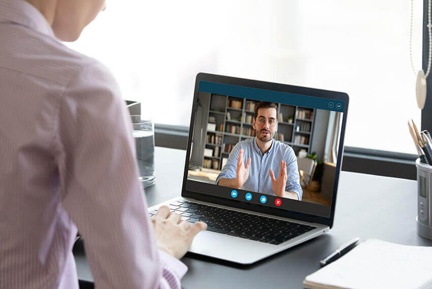 Interview between two professionals  via laptop.