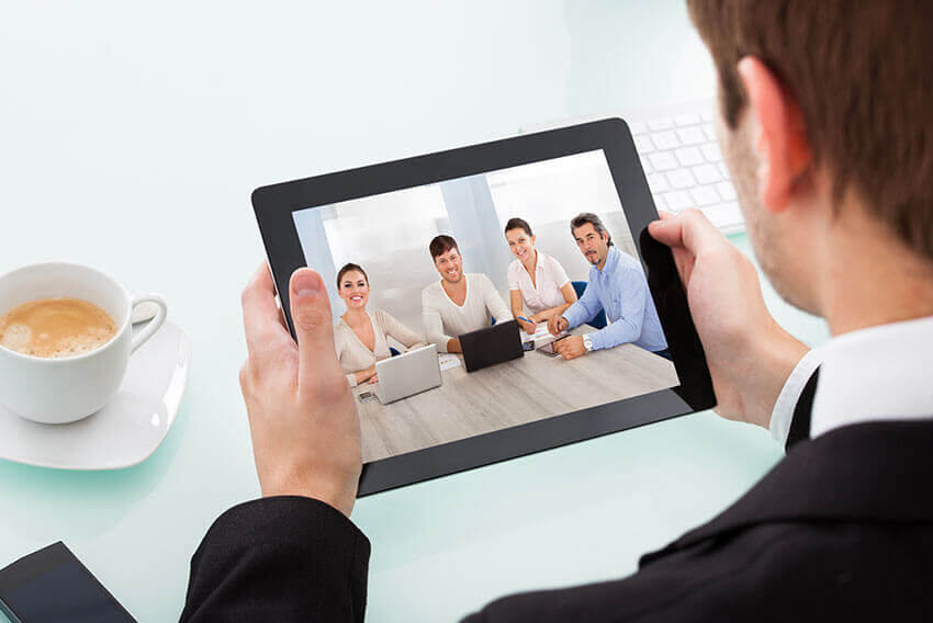 Professional man having a video conference on his tablet.