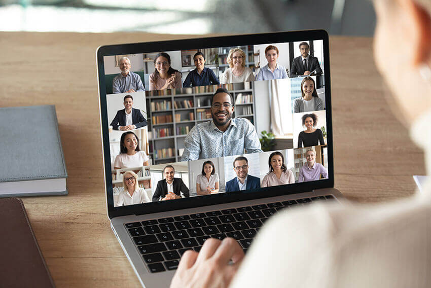 Person looking at laptop screen while on group chat