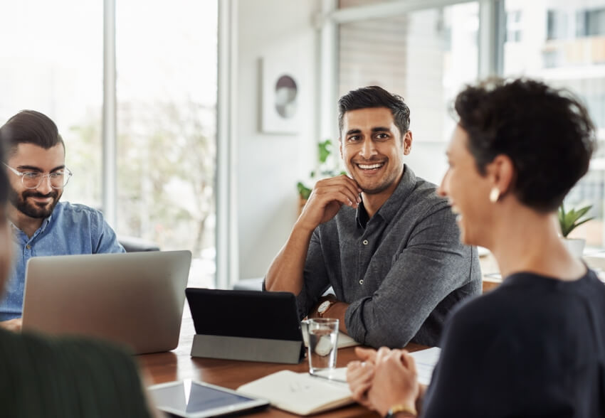 Employees engaged in conversation during a meeting.