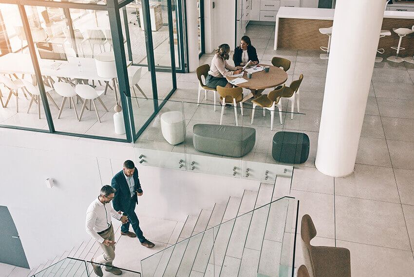 Overhead view of two professional colleagues  walking and talking. Aston Carter Recruitment Articles.