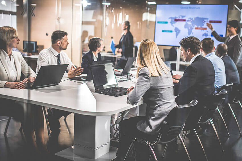 Conference room filled with professionals collaborating. 