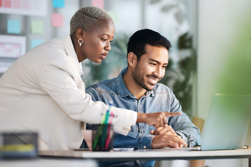 Male and female reviewing the July 2024 jobs report looking at June labor market trends.