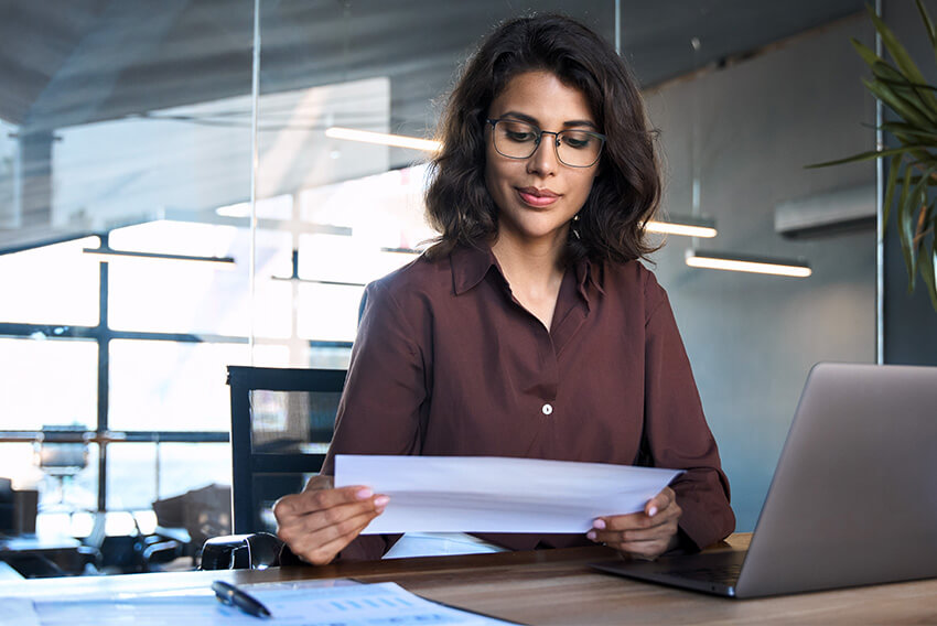 Female professional reviewing the June 2025 jobs report looking at May labor market and economy trends.