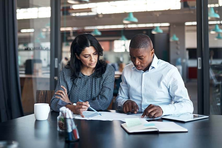 Two workers discussing a labor report.