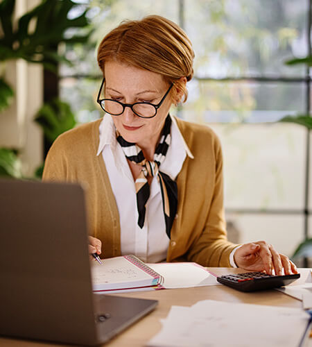 Female professional reading about the recent impact of tariffs on accounting and finance professionals.