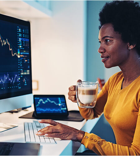A female reviewing data on a laptop about the affects of the tariffs on accounting and finance professionals.