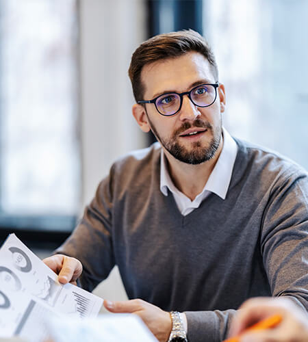 A male professional reviewing data on the affects of tariffs on accounting and finance professionals.