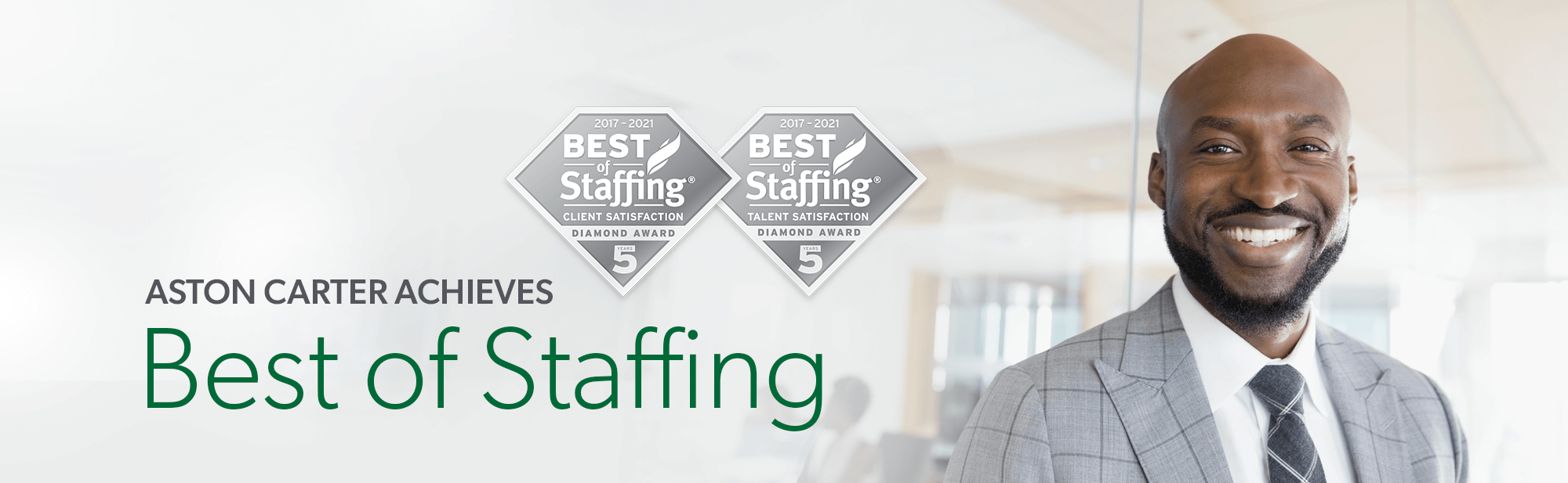 Aston Carter achieves best of staffing 2021; african american man, in a suite, smiling at camera