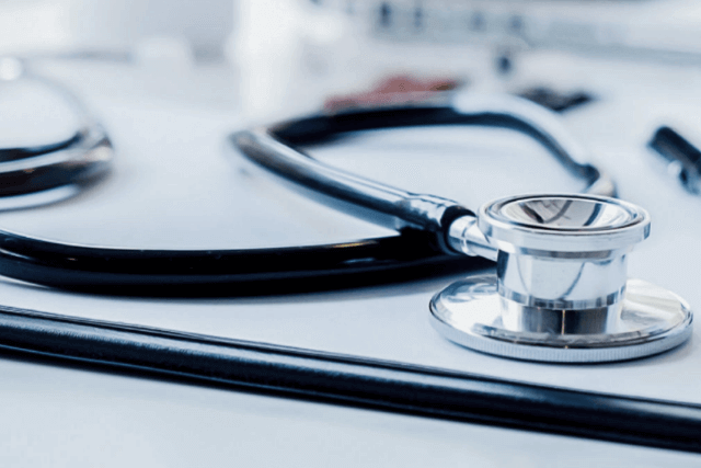 Up-close image of a stethoscope on a desk.