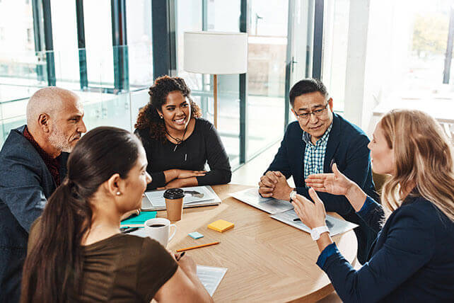 Aston Carter Services Business Disciplines Projects, Change, Transformation. Diverse group of 5 business individuals discussing new objectives.