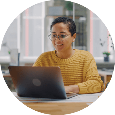 A female client searching on her laptop for business operations and administrative staffing solutions.